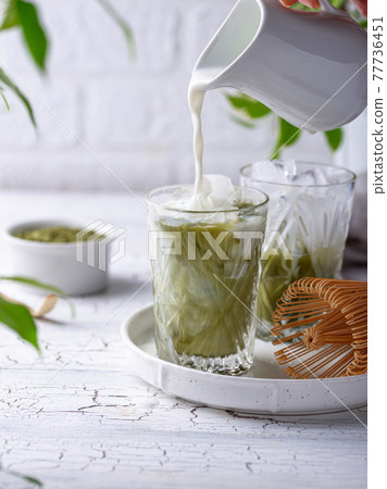 Cold matcha tea with milk and ice Cold matcha tea with milk and ice 77736451