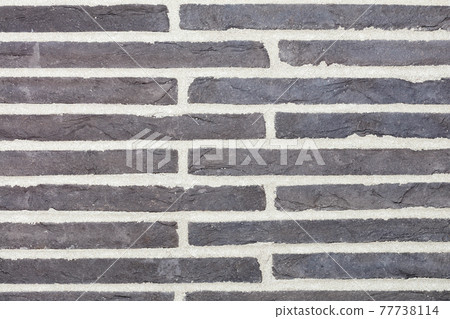 Texture of dark gray horizontal stone slabs embedded in the wall. Texture of dark gray horizontal stone slabs embedded in the wall. 77738114