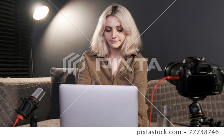 Young content creator girl working on her laptop Young content creator girl working on her laptop 77738746