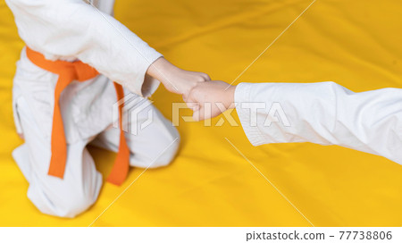 Two boys sitting on the ring in a gym Two boys sitting on the ring in a gym 77738806