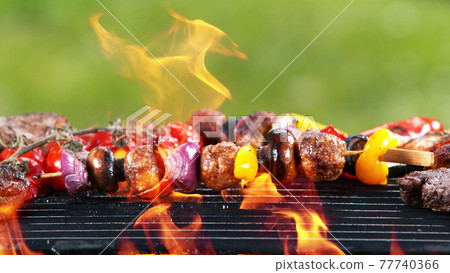 Delicious grilled skewer meat with vegetables. Delicious grilled skewer meat with vegetables. 77740366