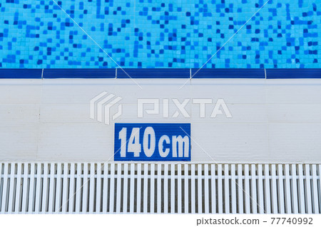 photo of pool edge with 140cm text on it. Safety in pool. Swimming training and exercises 77740992