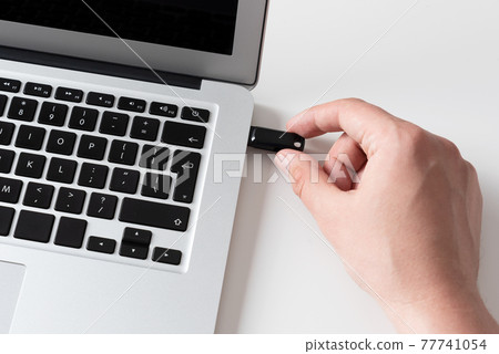 Hand connecting USB flash drive. USB flash memory Hand connecting USB flash drive. USB flash memory 77741054