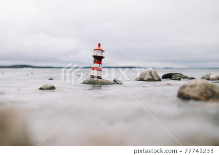 Sea with decorative lighthouse. Nautical lifestyle. Winter, Sea, Travel, adventure, holidays and vacation concept. Travel in 2021 Sea with decorative lighthouse. Nautical lifestyle. Winter, Sea, Travel, adventure, holidays and vacation concept. Travel in 2021 77741233
