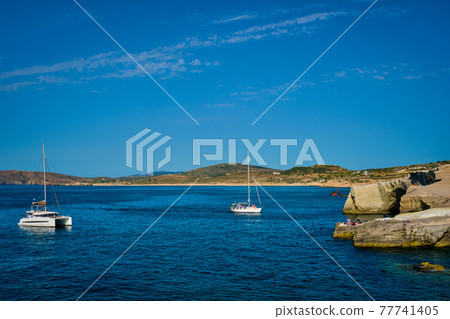 Yacht boat at Sarakiniko Beach in Aegean sea, Milos island , Greece 77741405