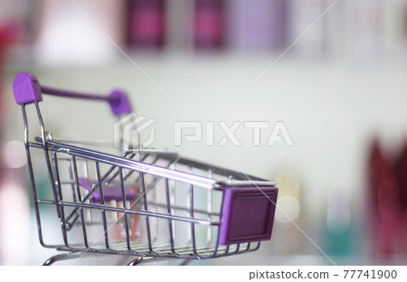 Empty shopping basket with blurred cosmetics in 77741900