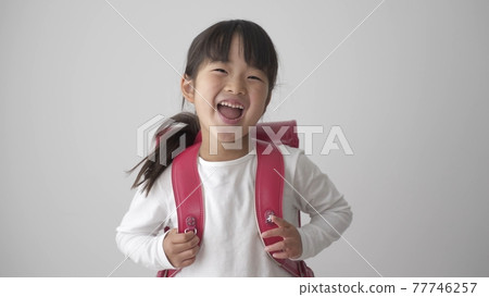 Girls carrying a school bag Girls carrying a school bag 77746257