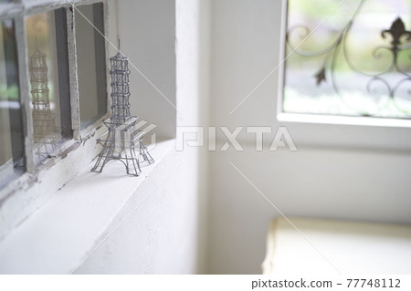 An image of a tower accessory by a bright window 77748112