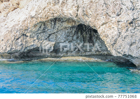 Large cave washed by the sea in a rock in Cyprus 77751068