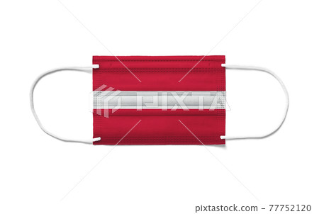 Flag of Latvia on a disposable surgical mask. White background Flag of Latvia on a disposable surgical mask. White background 77752120