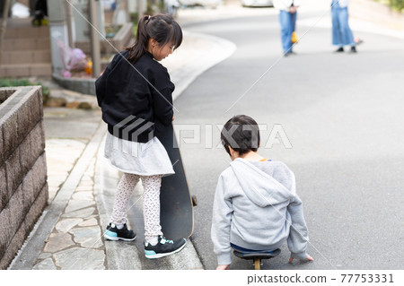 Kids playing skateboarding with friends Kids playing skateboarding with friends 77753331