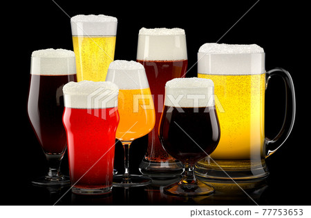 Set of fresh different beer glasses with bubble froth on black background. 77753653