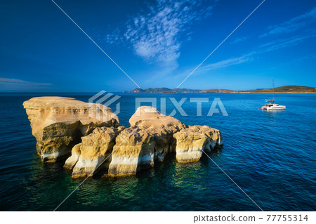 Yacht boat at Sarakiniko Beach in Aegean sea, Milos island , Greece 77755314