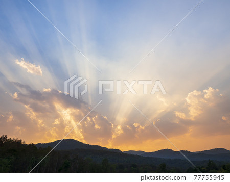 Clouds and sunbeam over the mountain in evening. Clouds and sunbeam over the mountain in evening. 77755945