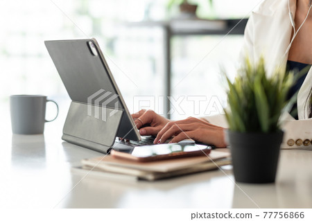 Close up businesswoman using digital tablet with blank white screen at office Close up businesswoman using digital tablet with blank white screen at office 77756866