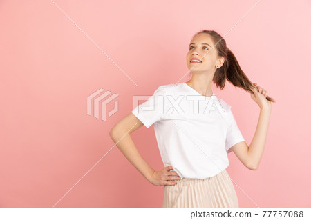Caucasian young woman's portrait isolated over pink studio background with copyspace Caucasian young woman's portrait isolated over pink studio background with copyspace 77757088