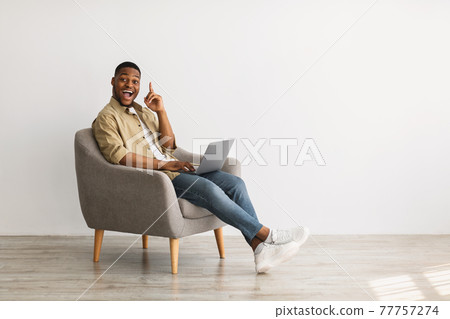 Black Guy With Laptop Having Idea Sitting In Chair Indoor 77757274