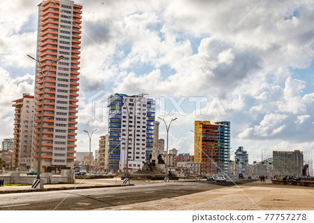 Modern resedential buildings close to Malecon promenade and road with cars, Vedado, Havana, Cuba 77757278