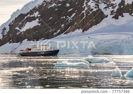 Touristic antarctic cruise liner drifting in the lagoon among th 77757366