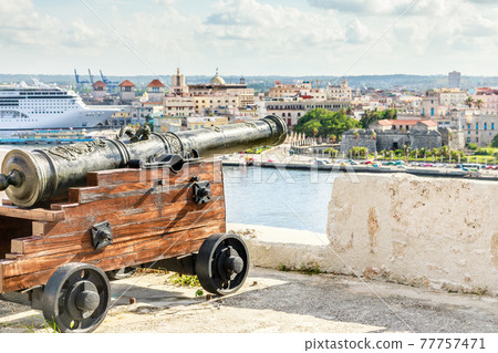 El Morro spanish fortress with cannon aimed to Havana city and liner docked in the port, Havana, Cuba 77757471