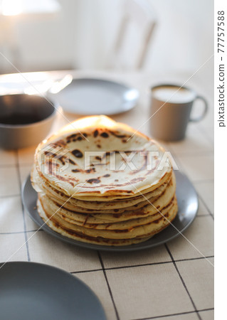 Stack of delicious homemade pancakes on a plate with coffee. Good morning, breakfast concept. Food photography. Copy space, flat lay Stack of delicious homemade pancakes on a plate with coffee. Good morning, breakfast concept. Food photography. Copy space, flat lay 77757588