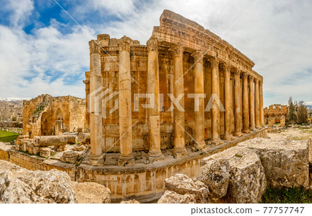 Columns of ancient Roman temple of Bacchus with surrounding ruin 77757747