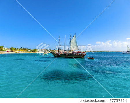 Tourists snorkeling along the coastline and enjoy the tropical island of Aruba Tourists snorkeling along the coastline and enjoy the tropical island of Aruba 77757834