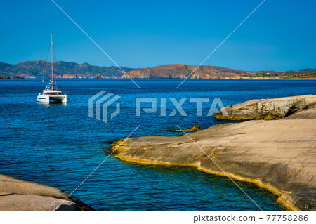 Yacht boat at Sarakiniko Beach in Aegean sea, Milos island , Greece Yacht boat at Sarakiniko Beach in Aegean sea, Milos island , Greece 77758286