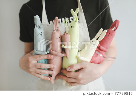Woman holding handmade toys, home workshop. DIY, work as a hobby concept. Making toys at home Woman holding handmade toys, home workshop. DIY, work as a hobby concept. Making toys at home 77759815