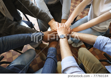 Top view of diverse people hands holding together in circle, hands stack Top view of diverse people hands holding together in circle, hands stack 77760184