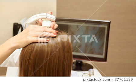 Woman check head hair in clinic. Woman check head hair in clinic. 77761159