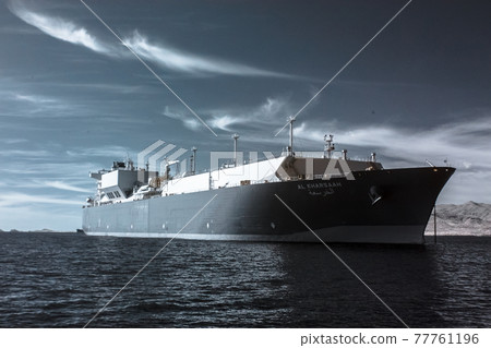 Industrial LNG tanker on the ocean behind a backdrop of calm clouds, infrared Industrial LNG tanker on the ocean behind a backdrop of calm clouds, infrared 77761196