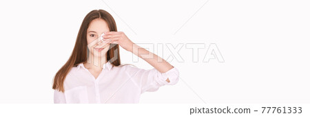 Female teenager person. Cleansing dirty skin. Remove mascara. Cotton pad face 77761333