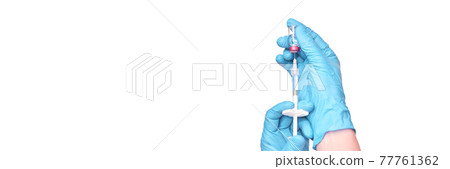 Male person in green glove hold vaccine bottle with syringe. Injection pharmacy 77761362