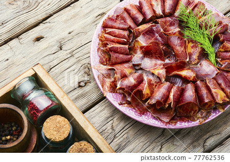 Spicy beef jerky on wooden background,basturma Spicy beef jerky on wooden background,basturma 77762536