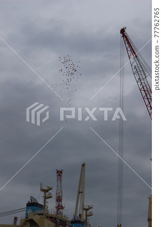 Balloons flying in the sky at the delivery ceremony of the new ship 77762765