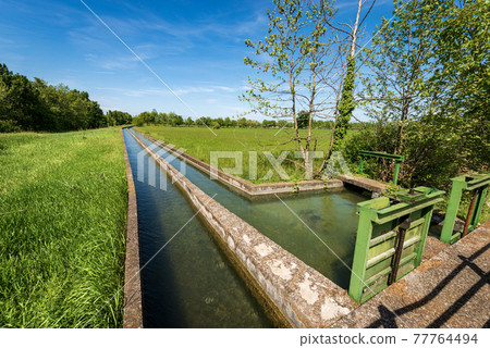 Two Small Concrete Irrigation Canals a Rural Scene - Padan Plain Italy Two Small Concrete Irrigation Canals a Rural Scene - Padan Plain Italy 77764494
