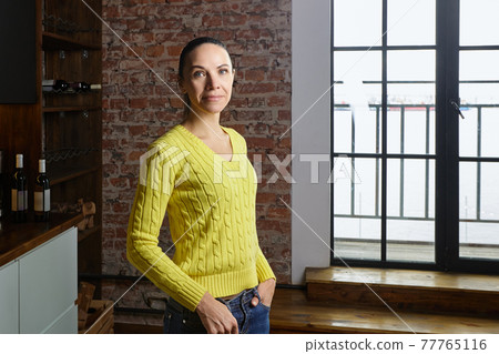 Elegant slender woman of about 40 years indoors. Elegant slender woman of about 40 years indoors. 77765116