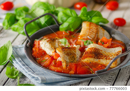 Delicious grilled fish with tomato sauce Delicious grilled fish with tomato sauce 77766003
