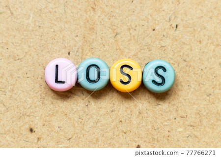 Round color bead with black letter in word loss on wood background Round color bead with black letter in word loss on wood background 77766271