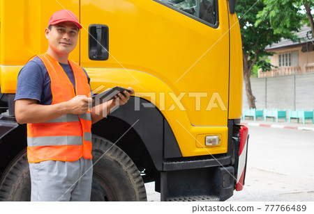 truck driver in safety clothes smile confident. 77766489