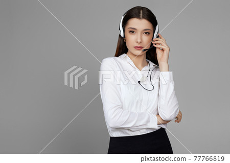 caucasian woman with headset on gray background caucasian woman with headset on gray background 77766819