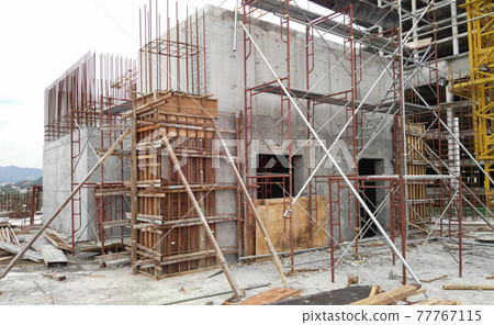 KUALA LUMPUR, MALAYSIA -SEPTEMBER 19, 2016: Column timber form work and reinforcement bar at the construction site. The structure supported by temporary wood support 77767115