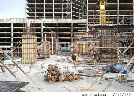 KUALA LUMPUR, MALAYSIA -SEPTEMBER 19, 2016: Column timber form work and reinforcement bar at the construction site. The structure supported by temporary wood support 77767120
