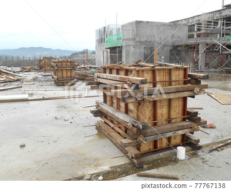 KUALA LUMPUR, MALAYSIA -SEPTEMBER 19, 2016: Column timber form work and reinforcement bar at the construction site. The structure supported by temporary wood support 77767138