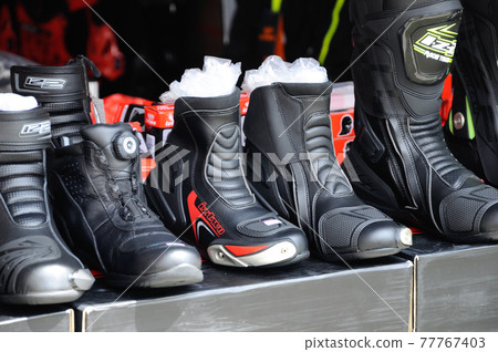 KUALA LUMPUR, MALAYSIA -FEBRUARY 25, 2017: The Various model of motorcycle rider boots displays for sale. It was made from selected leather and waterproof. KUALA LUMPUR, MALAYSIA -FEBRUARY 25, 2017: The Various model of motorcycle rider boots displays for sale. It was made from selected leather and waterproof. 77767403