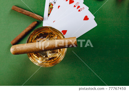 Cigar and playing cards on casino table Cigar and playing cards on casino table 77767450