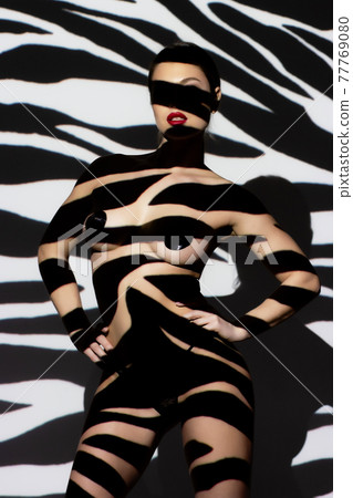 Fashion portrait of young lady with shadow on her body 77769080
