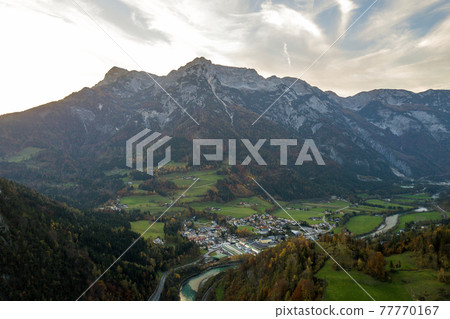 Aerial view of green meadows with villages and forest in austrian Alps mountains. 77770167