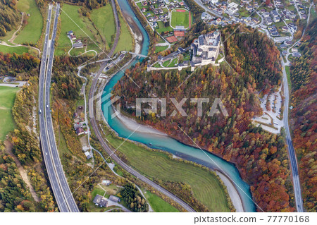 Aerial view of green meadows with villages and forest in austrian Alps mountains. 77770168